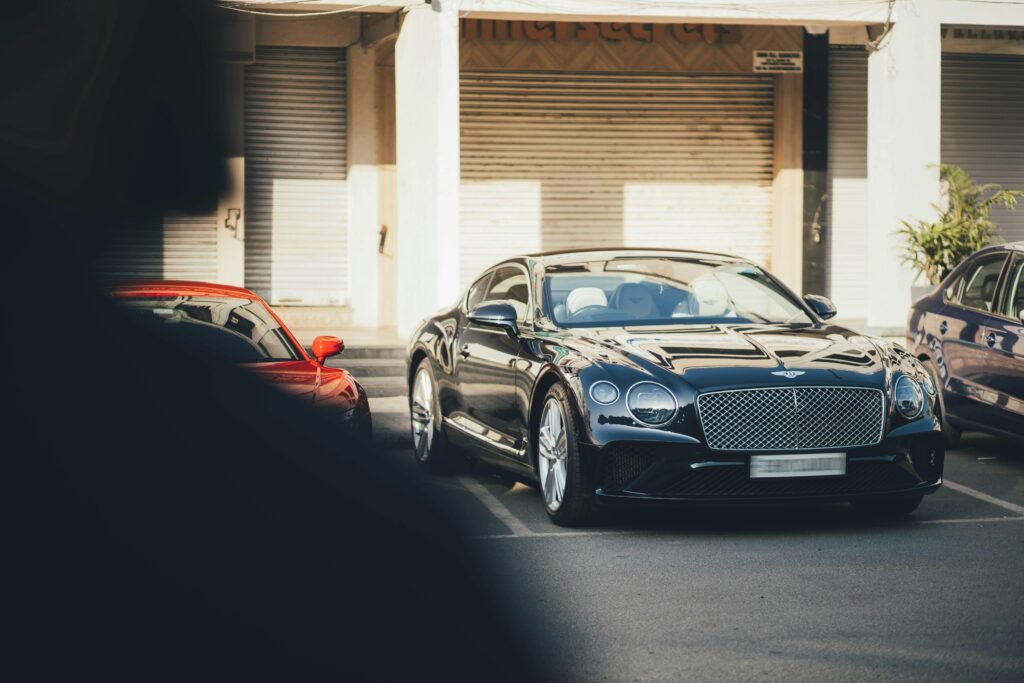 A sleek black Bentley Continental parked in an urban setting in Chandigarh, India.